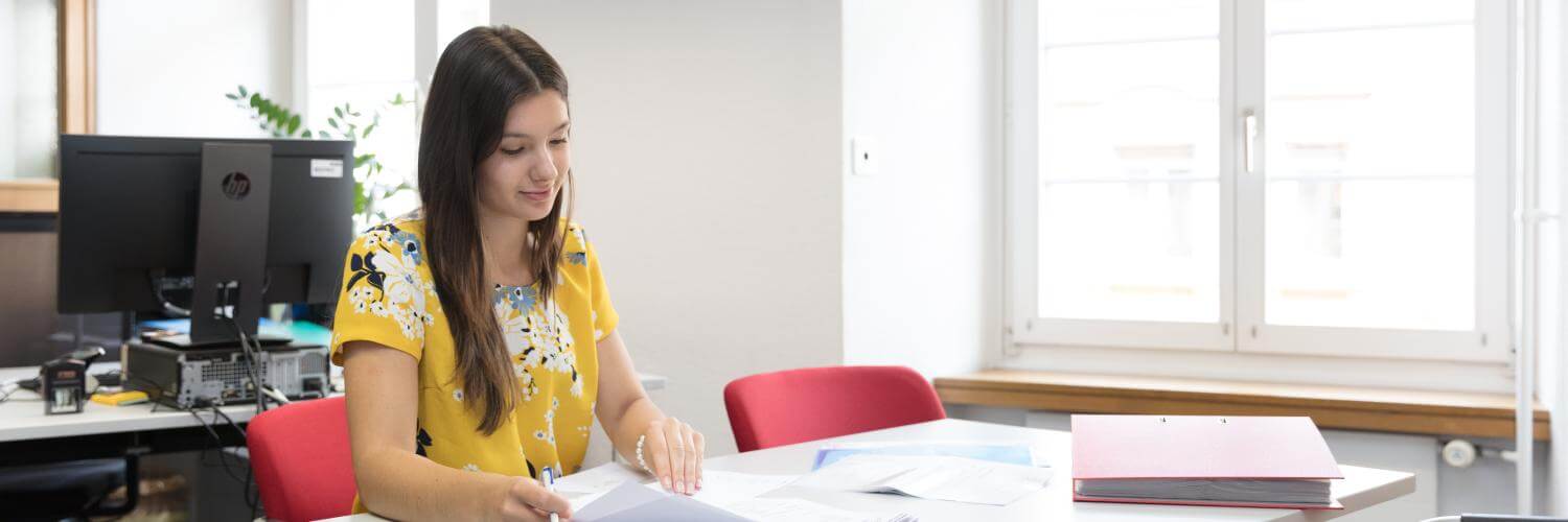 Lernende Kauffrau mit Berufsmaturität am Arbeitsplatz